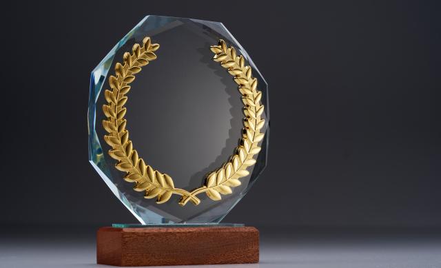 Octagonal-shaped, glass award with wooden base